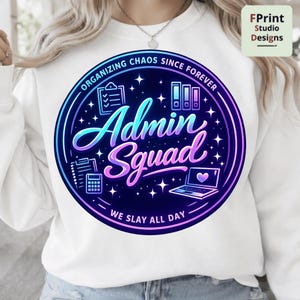 May include: White sweatshirt with a circular graphic. The graphic features the words "Organizing Chaos Since Forever" and "Admin Squad" in a gradient blue and purple design. The graphic includes icons of office supplies and the text "We Slay All Day".