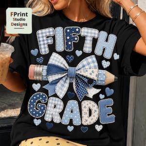 May include: A black t-shirt featuring the text FIFTH GRADE in blue and white patterns. A central pencil graphic is adorned with a large blue and white gingham and polka dot bow. Small blue and white hearts are scattered around the text and pencil.