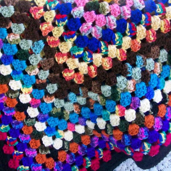 Crocheted  granny square afghan in multi colors with black trim 36"x38"