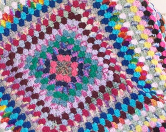 Crocheted multi-colored granny square afghan