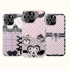 May include: Three smartphone cases featuring pink and white designs with black lace, ribbons, and heart motifs. The left case has a corset-style lace-up pattern, the center case has a quilted diamond texture with hearts, and the right case has polka dots.