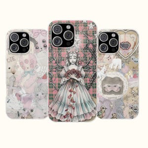 May include: Three smartphone cases featuring intricate graphic illustrations. The left case displays a collage of pink toys and dolls. The center case shows a figure in a dress holding roses against a plaid background. The right case depicts a heart with teeth.