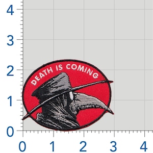 May include: An oval-shaped embroidered patch featuring a plague doctor in grey and black on a red background. The text "DEATH IS COMING" is stitched in white along the top curve. A ruler shows the patch is approximately 3 inches wide and 2 inches tall.
