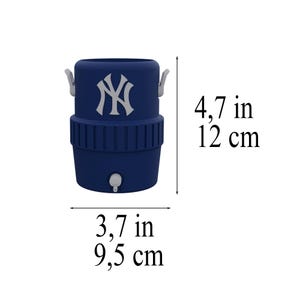 May include: A navy blue beverage cooler with the New York Yankees logo. The cooler is 4.7 inches tall and 3.7 inches wide. It has a spigot and two handles. The logo is white and is on the top portion of the cooler.