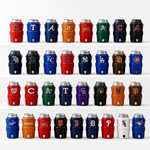May include: A collection of insulated water coolers in various colors, each featuring a team logo from Major League Baseball. The coolers have a silver lid and a small spigot at the bottom. The colors include red, blue, green, and orange.