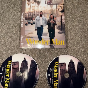 May include: A DVD set of the Marvel series "Wonder Man: The Complete First Season." The cover features two men walking down a street. Two DVDs are visible, each with the show's title and a large "W" design.