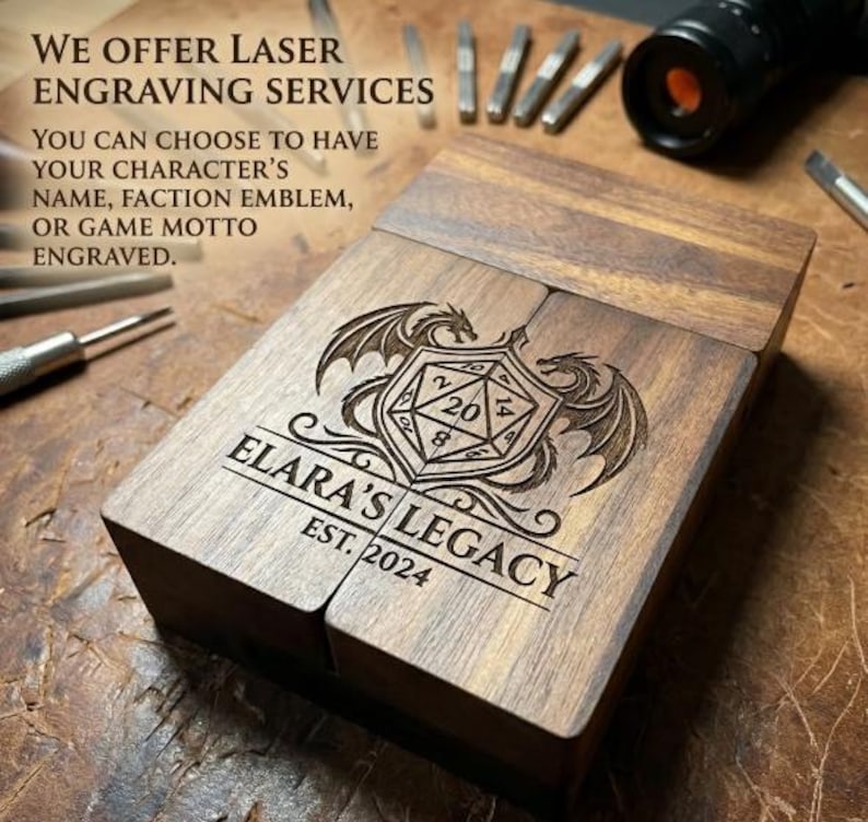 May include: A rectangular dark wood box featuring a laser-engraved design of a twenty-sided die flanked by two dragons. The text reads: WE OFFER LASER ENGRAVING SERVICES. YOU CAN CHOOSE TO HAVE YOUR CHARACTER'S NAME, FACTION EMBLEM, OR GAME MOTTO ENGRAVED. ELARA'S LEGACY EST. 2024.