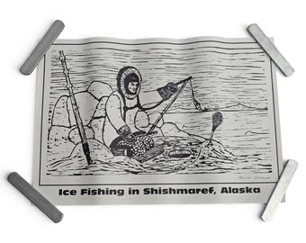 May include: A black and white print titled Ice Fishing in Shishmaref, Alaska, depicting a person in a fur-lined parka sitting on ice, holding a fishing rod over a hole, with a spear and a small tool nearby, all rendered in a detailed line art style.