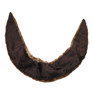 May include: A brown fur stole with a brown satin lining. The stole is shaped like a crescent moon.