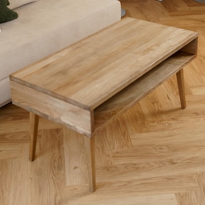 May include: A set of three ceramic mugs with a speckled, matte finish. The mugs are in shades of cream, light gray, and dark gray. Each mug has a simple, minimalist design and a rounded handle.