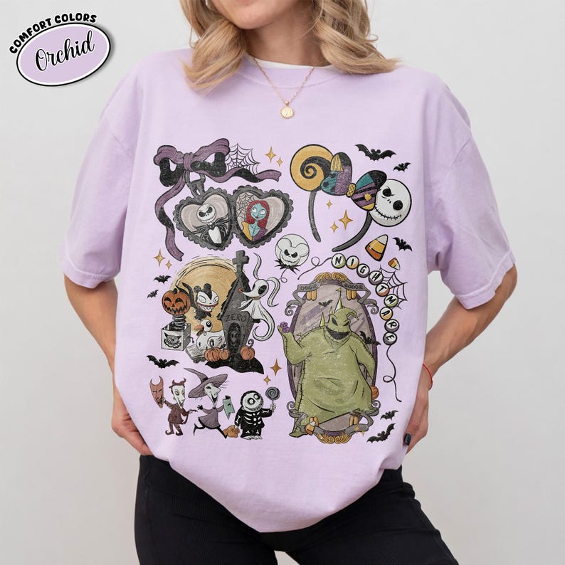 May include: A light purple t-shirt featuring a graphic print of characters from The Nightmare Before Christmas, including Jack Skellington, Sally, Oogie Boogie, and Zero. The design includes a bow, spiderwebs, and the text Nightmare.