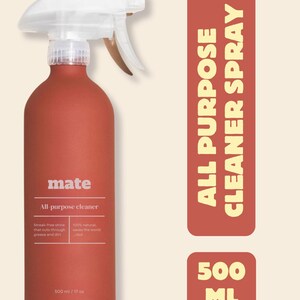 Puede incluir: Un pulverizador de limpiador multiusos de color terracota con una boquilla pulverizadora blanca. La botella tiene la palabra "mate" y "All-purpose cleaner" impresas. La etiqueta también indica "Brillo sin rayas que corta la grasa y la suciedad".
