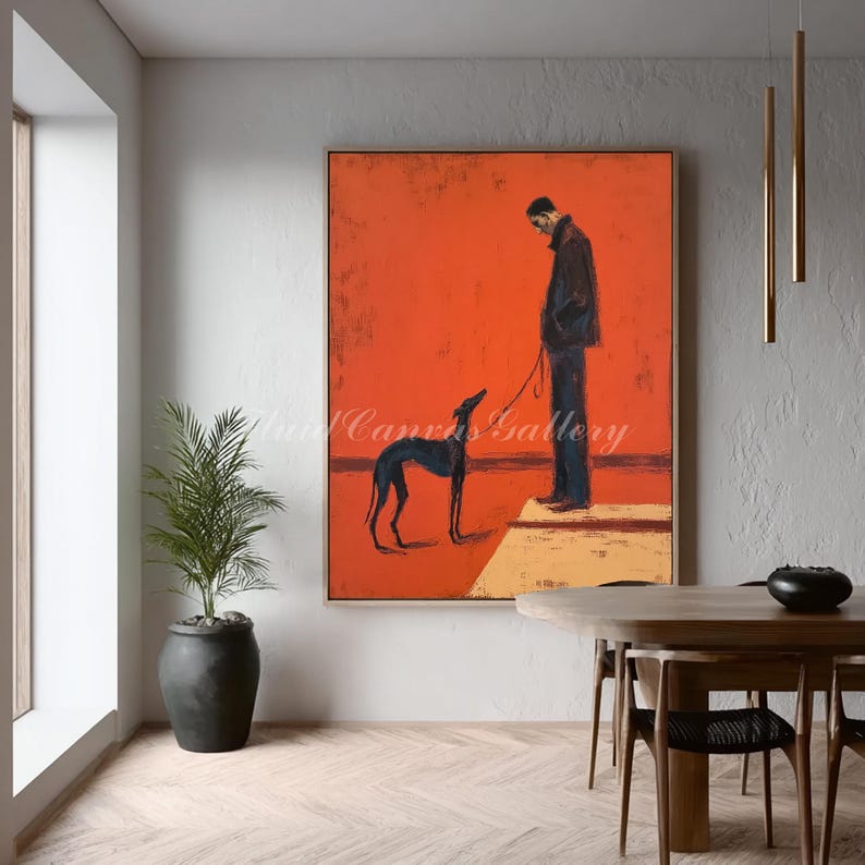 May include: An abstract painting features a person with a dog on a leash against a vibrant orange background. The dog is black, and the person is wearing a dark coat and pants. The artwork is framed and displayed in a modern interior.