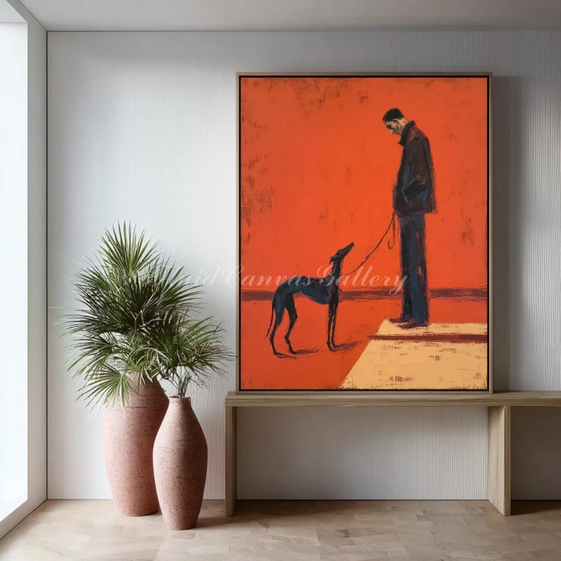 May include: An abstract painting featuring a person and a dog on a leash against a vibrant orange background. The artwork has a minimalist style with a dark-colored dog and a person in a dark coat. The painting is framed in a dark wooden frame.