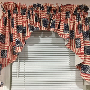May include: A red, white, and blue valance with a distressed American flag pattern. The valance is hung over a white window blind.