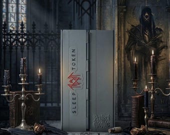 May include: A rectangular gray storage box with a hinged side, featuring the text SLEEP TOKEN and a red graphic logo on the front. The box also displays the embossed text Project Gothic at the bottom right corner, presented in a dark setting.