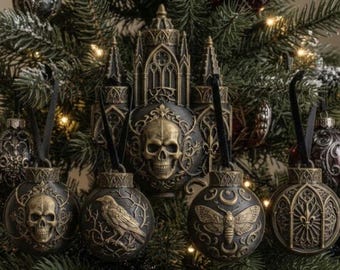 May include: A collection of dark-toned, gothic-inspired Christmas ornaments featuring intricate relief designs of skulls, a raven, a moth, and architectural arches, all finished in a metallic bronze and black color palette.