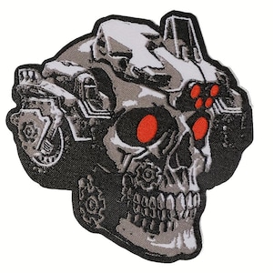 May include: A patch featuring a skull design with mechanical elements. The skull has bright red eyes and is detailed with gears and machinery. The patch is primarily gray, black, and white.
