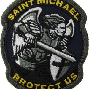 May include: Embroidered patch featuring Saint Michael, an angel with a sword and shield. The patch has a dark blue background with the words "SAINT MICHAEL PROTECT US" in yellow lettering. The border is gray.