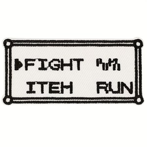 May include: A white rectangular patch with a black border and the words "FIGHT", "ITEM", and "RUN" in black, pixelated font. A black arrow points to the word "FIGHT". The patch has a retro video game aesthetic.