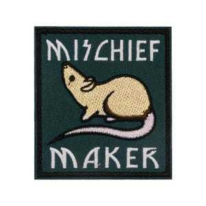 May include: Embroidered patch with a tan rat illustration on a dark green background. The patch features the words "MISCHIEF MAKER" in white, stylized lettering. The rat has a pink tail and is looking upwards.