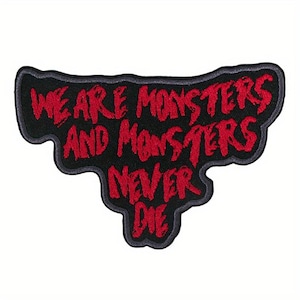 May include: Black embroidered patch with the text "WE ARE MONSTERS AND MONSTERS NEVER DIE" in red, stylized lettering. The patch has a unique, irregular shape with a gray border, suitable for jackets, bags, or other fabric items.