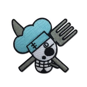 May include: Embroidered patch featuring a skull wearing a chef's hat and a fork crossed with a bone. The skull is white with a black eye and a stitched mouth. The chef's hat is light blue, and the fork and bone are gray.