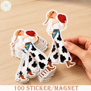 May include: A stack of die-cut stickers featuring a blonde character with braided hair wearing a white shirt, blue denim-style pants with black cow-print patterns, brown boots, and holding a red hat. The text 100 STICKER/MAGNET is visible.