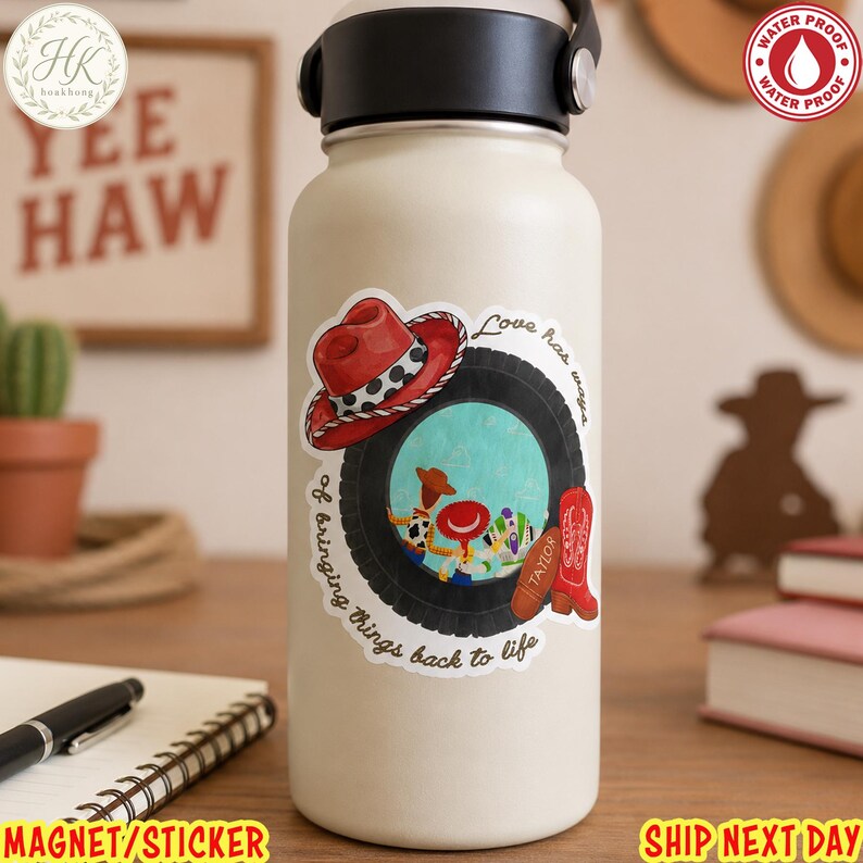 May include: A cream-colored water bottle featuring a sticker with a black tire, a red cowboy hat, and a red cowboy boot. Inside the tire is a graphic of two cartoon characters. The text reads, Love has ways of bringing things back to life.