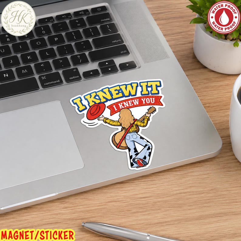 May include: A die-cut sticker featuring a cartoon character with long blonde hair, wearing a yellow plaid shirt and cow-print bell-bottom pants, playing an acoustic guitar. The text reads I KNEW IT I KNEW YOU with a red hat icon above.