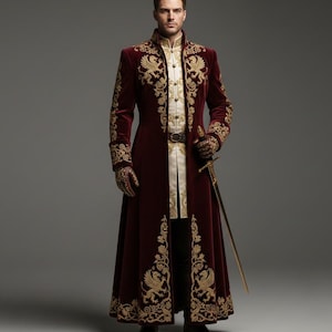 May include: A burgundy velvet coat with gold embroidery, featuring ornate floral and bird designs. The coat has a high collar and long sleeves, paired with matching gloves. A gold sword is held at the side. The outfit is a historical costume.