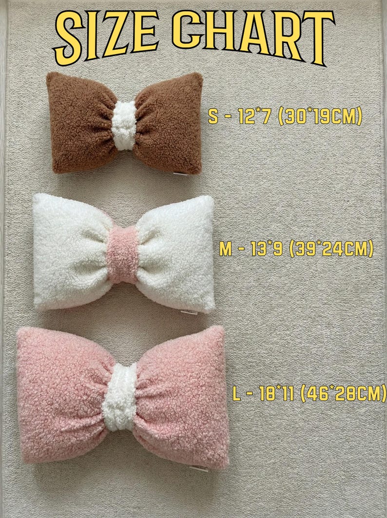 May include: Image shows a size chart for bow-shaped pillows. The chart displays three pillows in brown, white, and pink, with white centers. Sizes are S (12"x7"), M (13"x9"), and L (18"x11"). The text "SIZE CHART" is at the top.