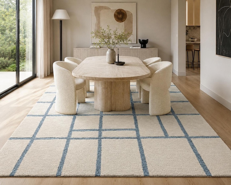 Minimalist hand tufted grid rug in cream, beige, and blue adding subtle texture to contemporary home decor.