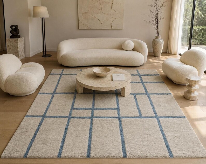 Hand tufted beige and blue grid rug with abstract windowpane pattern for modern minimalist living room decor.