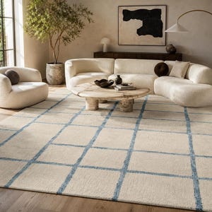 Rectangle hand tufted cream rug with modern blue grid pattern perfect for neutral living room and bedroom decor.