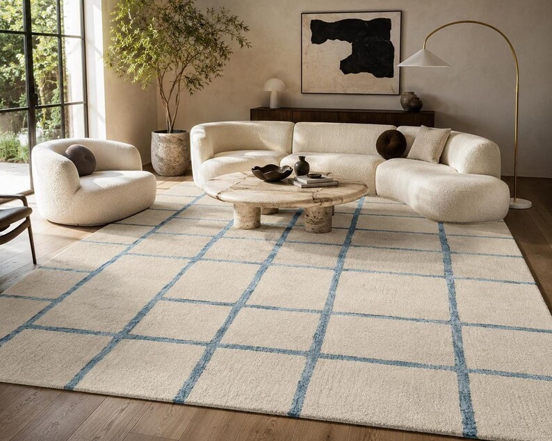 Rectangle hand tufted cream rug with modern blue grid pattern perfect for neutral living room and bedroom decor.
