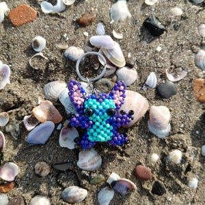 Beaded Keychain ​Stitch Bag Charm ​Handmade Gift ​Disney Fan Art ​Blue Purple Stitch ​Beadwork Animal ​Pixel Art Charm ​Cute Accessory ​Stocking Stuffer ​Lilo and Stitch ​Unique Keychain ​Boho Bag Decor ​Personalized Gift