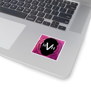 May include: A square sticker featuring a black silhouette of a head profile against a vibrant magenta and purple nebula-like background. The white capital letters MVH are centered within the black silhouette, creating a bold contrast.