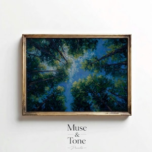 May include: An oil painting of a forest canopy, viewed from below, with tall trees reaching towards a blue sky. The artwork is framed in a gold-colored wooden frame. The text "Muse & Tone - Prints" is at the bottom.