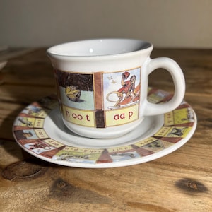 Vintage espresso cup and saucer featuring the iconic Dutch “Aap Noot Mies” reading board illustrations.