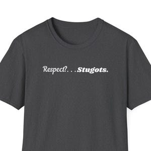 May include: Dark gray t-shirt with the text "Respect?... Stugots." in a white, stylized font. The shirt has a crew neck and short sleeves. The fabric appears to be a soft, comfortable material.