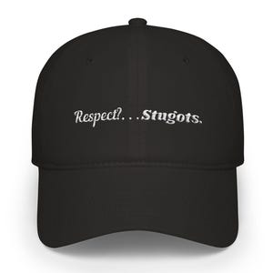 May include: Black baseball cap with a curved brim. The cap features the embroidered text "Respect?...Stugots" in white, centered on the front. The cap is a classic style, suitable for casual wear.