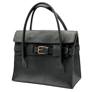 May include: Black leather handbag with a structured design. Features a flap closure secured by a belt with a gold-colored buckle. The bag has two top handles and a rectangular shape, suitable for everyday use.