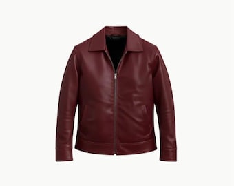 May include: A burgundy leather jacket with a collared neckline and a full-length zip. The jacket has a classic design with a tailored fit, suitable for various occasions. The jacket is a rich, solid colour.