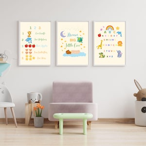 May include: Three framed nursery art prints. One print displays numbers 1-5 with corresponding images and words. Another print says "Dream Big Little One". The third print shows the alphabet with animal illustrations.