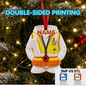May include: A white hoodie ornament with a yellow and orange safety vest, featuring a black lanyard with a circular pendant, a rolled blueprint, and a pocket with a compass icon. The text NAME is printed in orange above the vest.