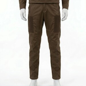 May include: Brown pants with two rectangular pockets on the thighs and white stitching. The pants are part of a matching set, with a long-sleeved top visible above. The pants are displayed on a mannequin.