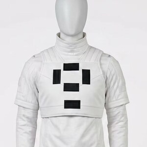 May include: A white futuristic-style outfit with a high collar and short sleeves. The chest area features a design of four black rectangles arranged in a square pattern. The outfit is made of a smooth, possibly leather-like material.