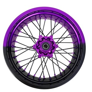 May include: A motorcycle wheel with a vibrant purple rim that fades to black. The wheel features black spokes and a matching purple hub, creating a striking contrast. The design is modern and eye-catching.