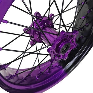 May include: Close-up of a motorcycle wheel with a vibrant purple hub and rim. The wheel features black spokes and a glossy finish, creating a striking contrast. The design highlights the intricate details of the wheel's construction.